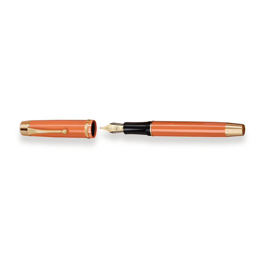 The Muse Fountain Pen by Webson Gill features a vibrant orange body, a gold-plated nib, and a matching gold-trimmed cap, all elegantly displayed on a white background.