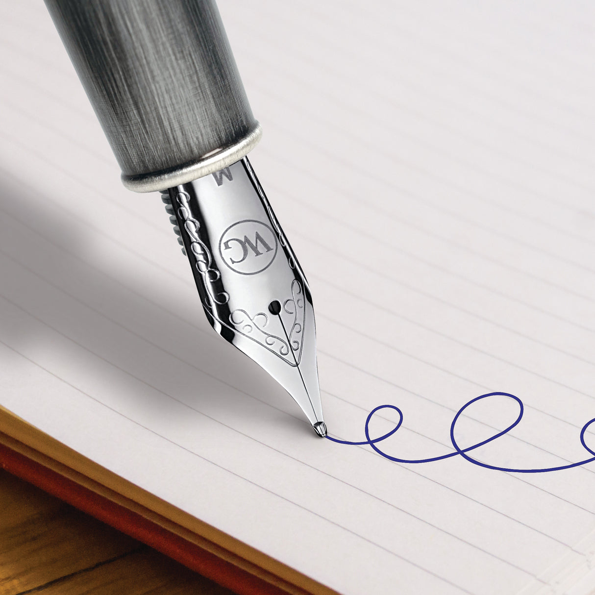 The Webson Gill 'Admiral' Premium Fountain Pen creates a blue, curly line across a lined notebook page.