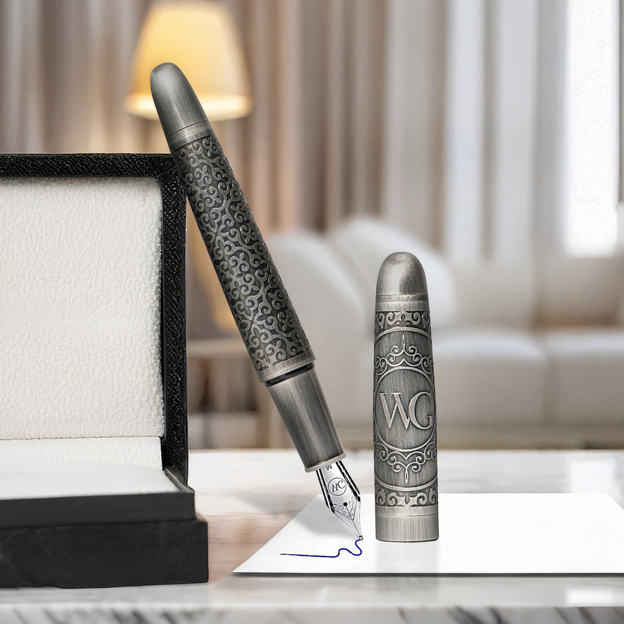 A Webson Gill 'Admiral' Premium Fountain Pen engraves words on paper next to its open box, set against a cozy living room backdrop.