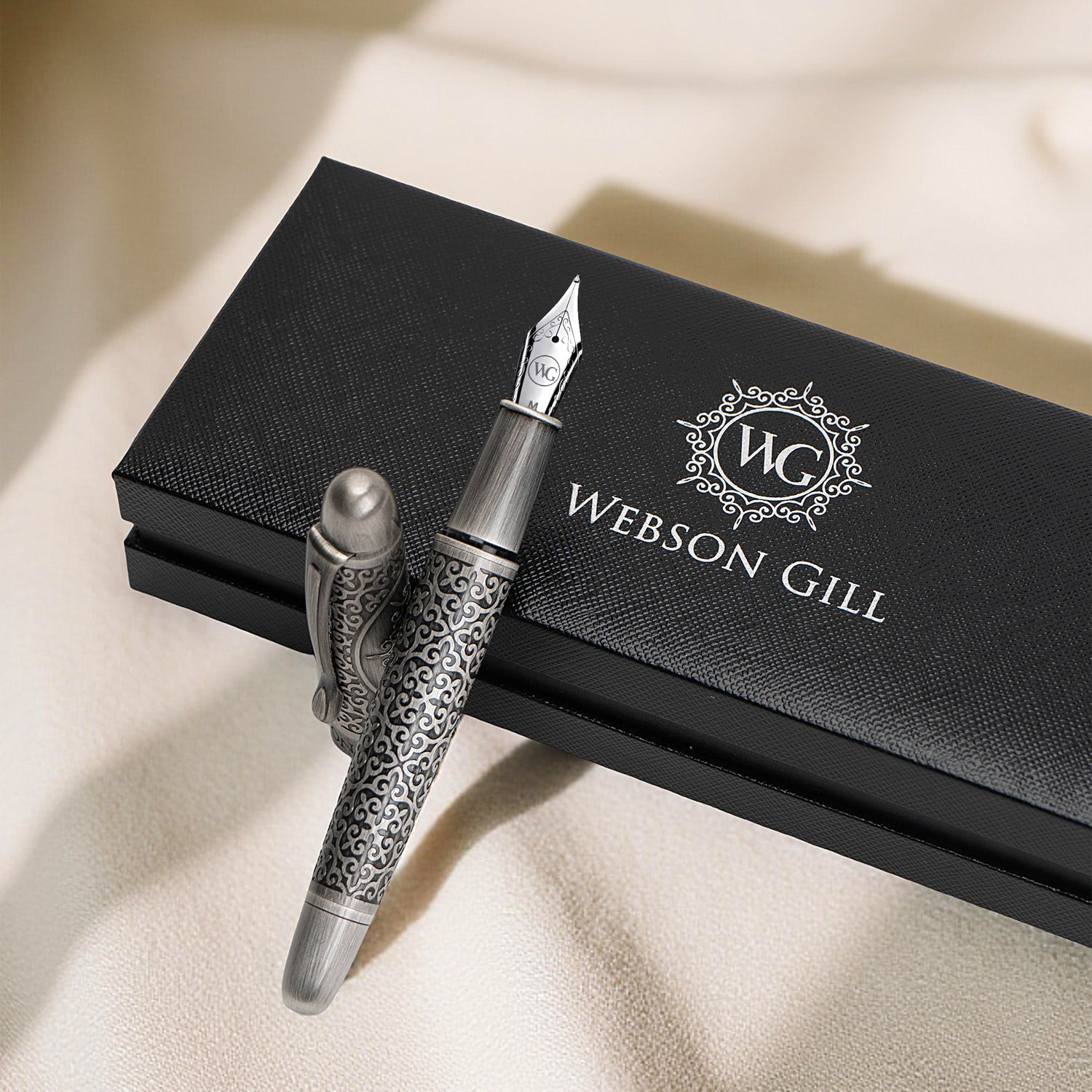The Admiral Fountain Pen by Webson Gill features an engraved brass design and comes elegantly presented in a black branded box, showcasing timeless luxury.