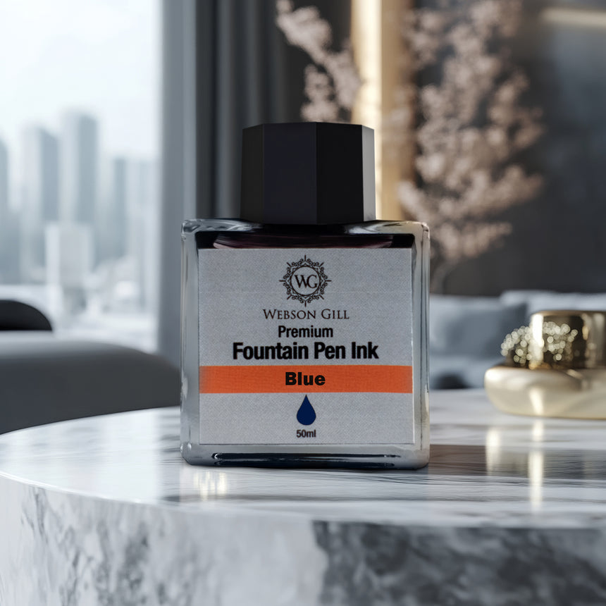 A bottle of Webson Gill 'Ink in a Bottle' Fountain Pen Refill—blue ink that fits all fountain pens—rests on a marble table in a modern room.