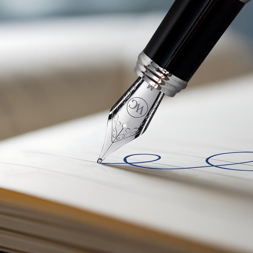 The Webson Gill 'The Mogul' Premium Fountain Pen features a stainless steel nib that creates elegant blue swirls on crisp white paper.