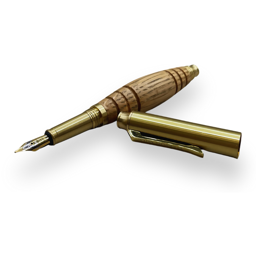 The 'Bourbon Barrel' Premium Fountain Pen by Webson Gill, featuring gold accents and cap, is crafted from reclaimed oak and displayed on a white background.