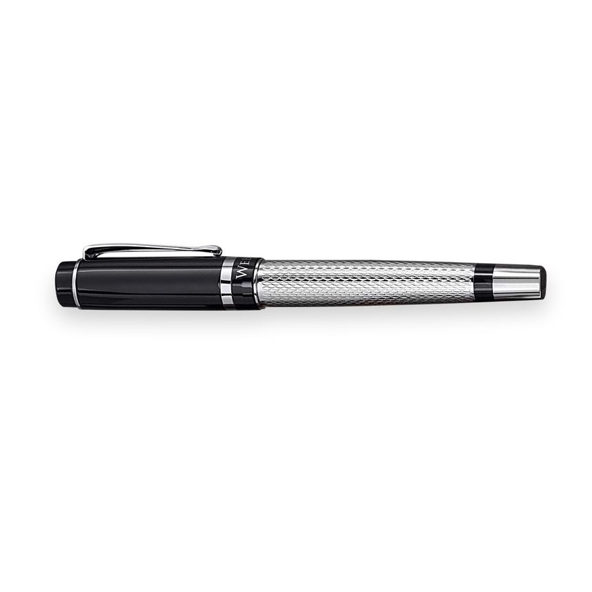 The WG ‘The Raider’ Everyday Fountain Pen, featuring a black and silver finish, textured barrel, stainless steel medium nib, and cap clip, is displayed elegantly on a white background.