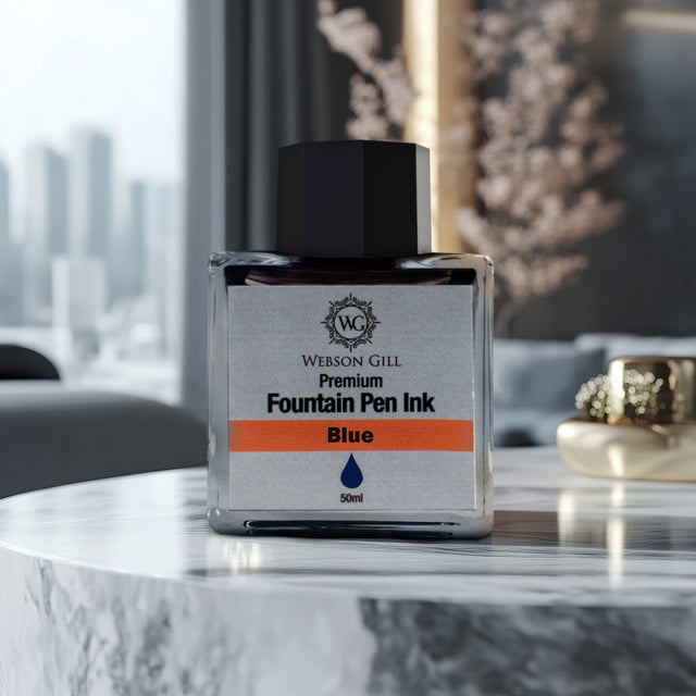 A jar of Webson Gill Ink Universal Fountain Pen Refill (Blue) rests on a marble table, with a blurred cityscape behind—a perfect choice for your fountain pen.