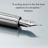 The WG ‘The Mirror’ Everyday Fountain Pen, featuring a stainless steel nib, rests elegantly inscribed with the quote, “A writing device is the link from epiphany to conception.”.