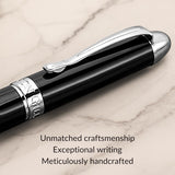 The WG 'The Boss' Everyday Fountain Pen, featuring a black and silver design with a stainless steel nib, rests on marble—its craftsmanship and smooth writing highly praised.