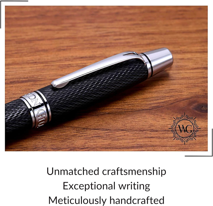 The WG 'Show Up' Everyday Fountain Pen, featuring a black and silver diamond guilloché finish and a stainless steel medium nib, rests on wood—its refined design reflecting WG's commitment to craftsmanship.