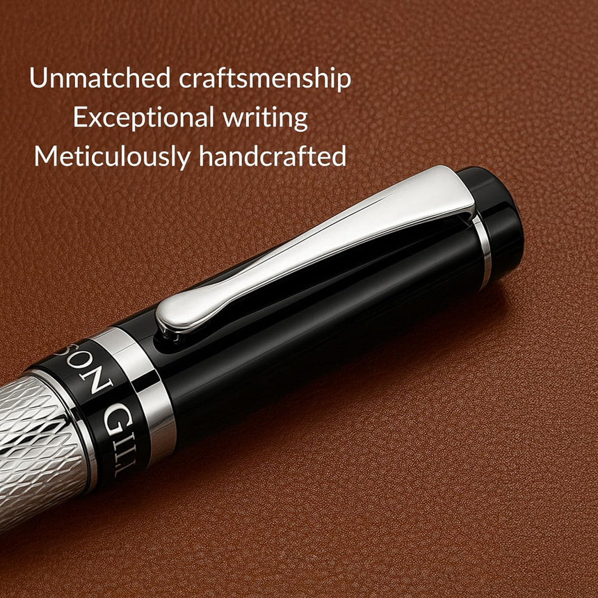 The WG 'The Raider' Everyday Fountain Pen features a black and silver design with a stainless steel medium nib on brown leather, showcasing its exceptional craftsmanship and executive quality.