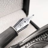 Close-up of the Admiral Fountain Pen by Webson Gill, featuring a silver nib with intricate designs and an antique silver finish, displayed in a decorative case.