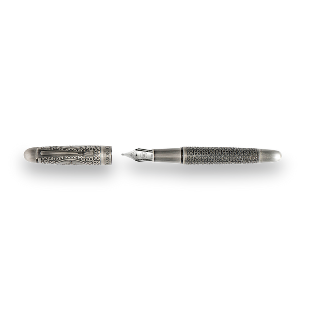 The Webson Gill Admiral Fountain Pen, shown uncapped, boasts an antique silver finish and intricate engravings on the cap and barrel—an impressive example of artistic craftsmanship.