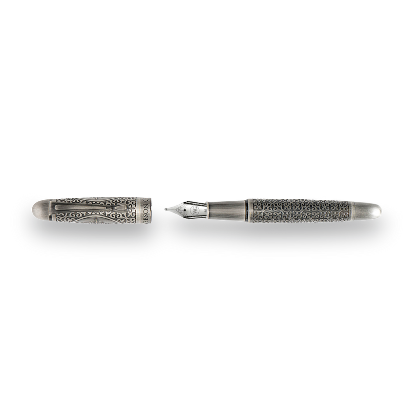 The Webson Gill Admiral Fountain Pen, shown uncapped, boasts an antique silver finish and intricate engravings on the cap and barrel—an impressive example of artistic craftsmanship.