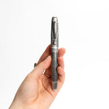 A hand holds the Webson Gill Admiral Fountain Pen, featuring intricate engraved patterns and an elegant design, against a white background.