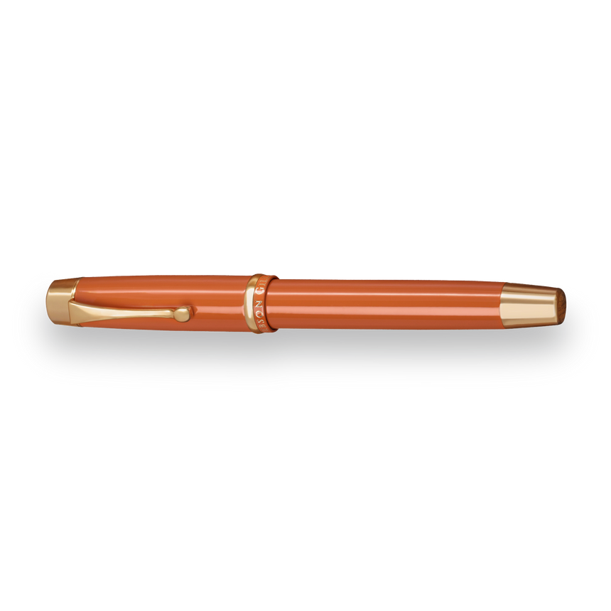 The Muse Fountain Pen by Webson Gill, with an orange body, gold-plated nib, gold accents, and a clip, is displayed on a white background.
