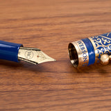 The Regal Fountain Pen by Webson Gill features a blue and gold design with an ornate brass filigree cap—a must-have for fountain pen collectors.